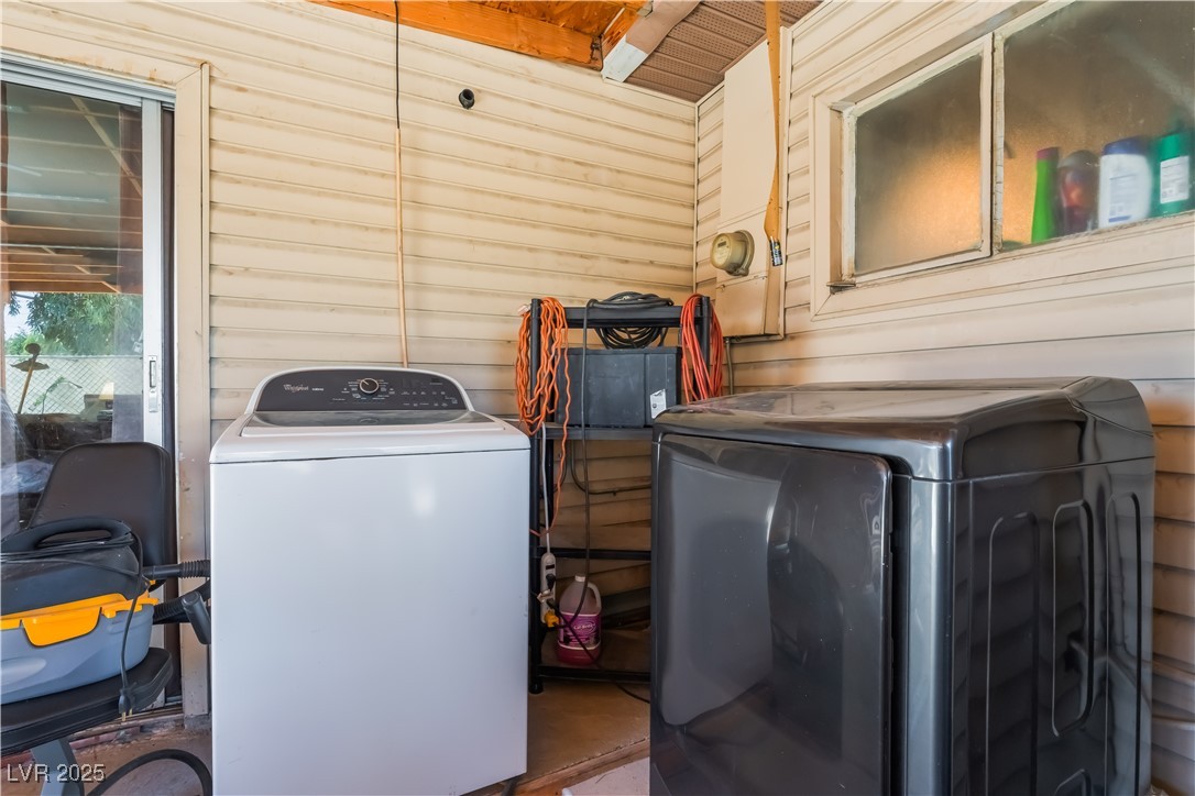 1908 Ardmore Street Las Vegas, NV 89104 - Photo 22 of 29 Laundry area featuring washing machine and clothes dryer, wooden walls, and a desk