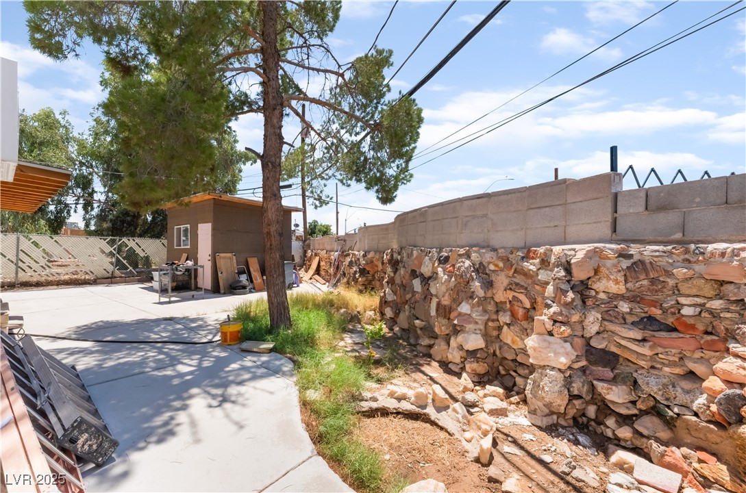 1908 Ardmore Street Las Vegas, NV 89104 - Photo 26 of 29 Fenced backyard featuring a patio area and a storage shed