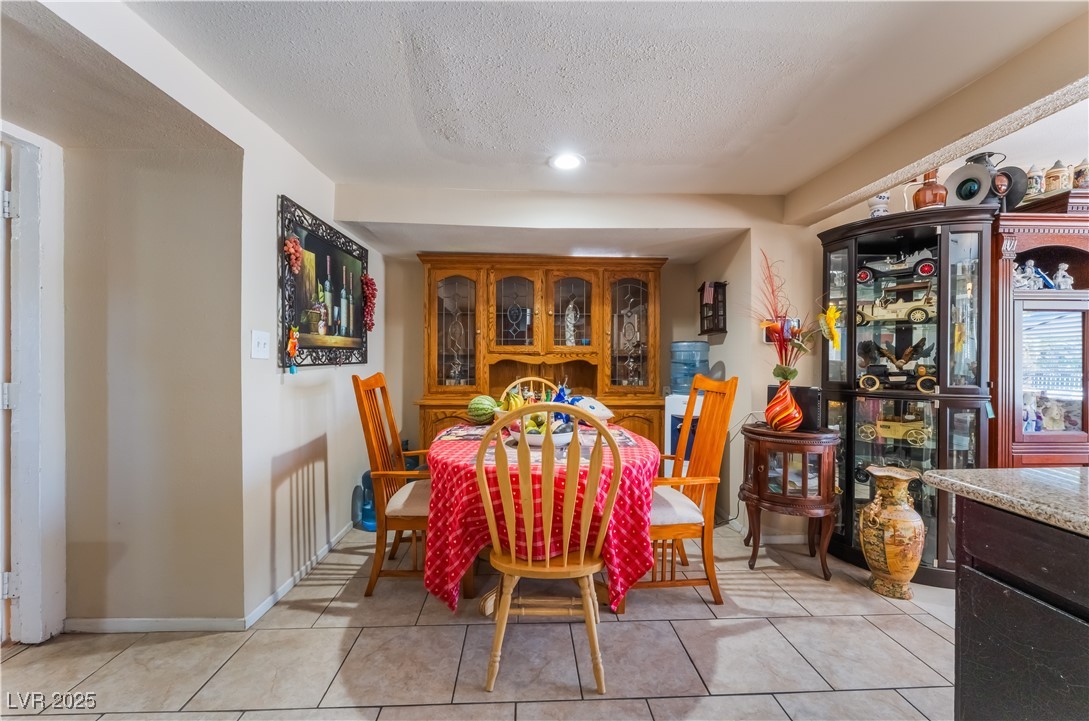 1908 Ardmore Street Las Vegas, NV 89104 - Photo 10 of 29 Dining room with a textured ceiling, light tile patterned flooring, and recessed lighting