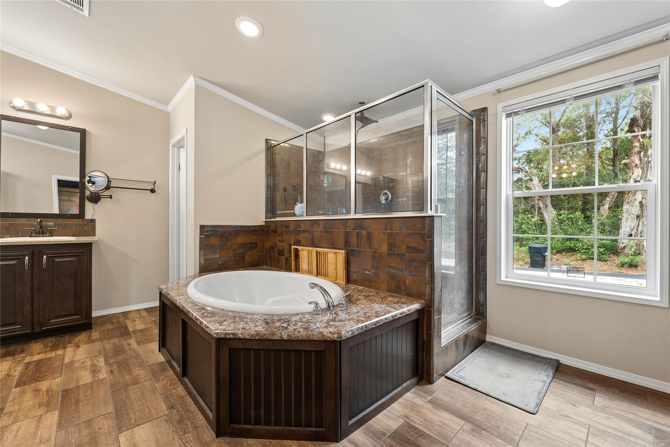 1024 Sand Hills Road Red Rock, TX 78662 - Photo 15 of 40 Primary bathroom featuring soaking tub and glass-enclosed shower, perfect for unwinding after a long day.