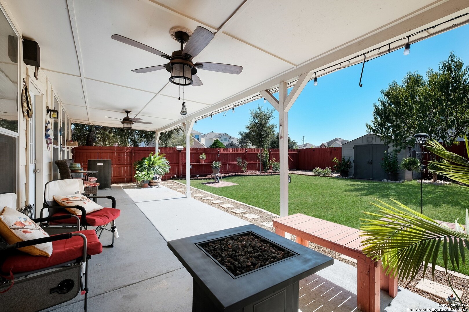 a view of a backyard with garden and a patio