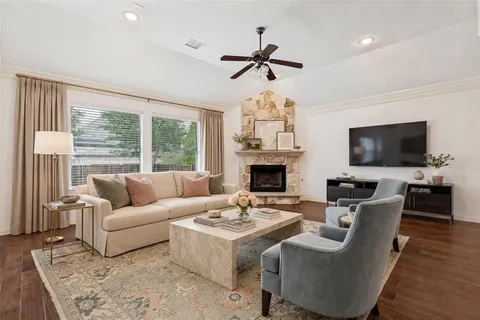 a living room with furniture a fireplace and a flat screen tv