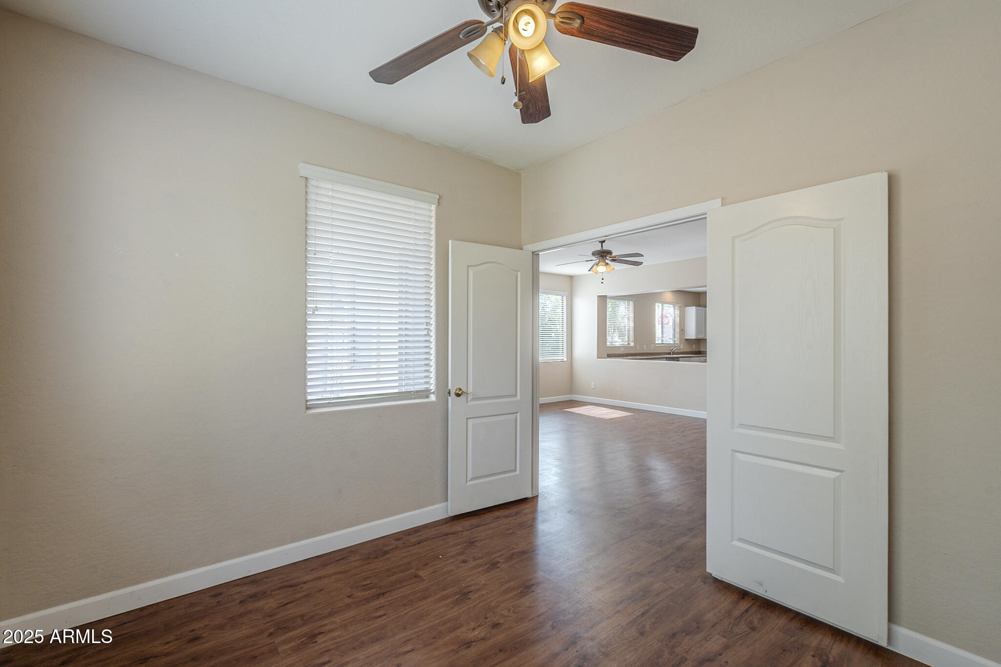 15902 West Hearn Road Surprise, AZ 85379 - Photo 17 of 73 a view of empty room with wooden floor and fan