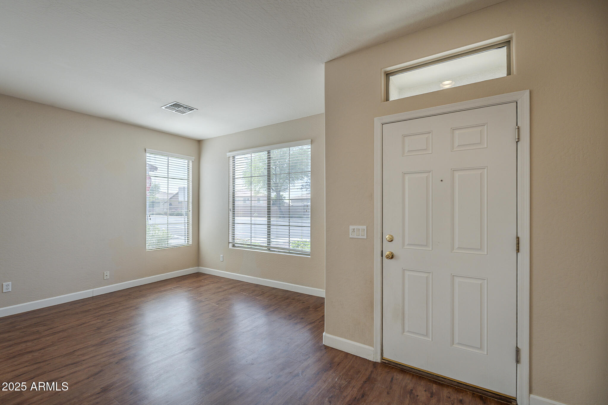 15902 West Hearn Road Surprise, AZ 85379 - Photo 29 of 73 an empty room with wooden floor and windows