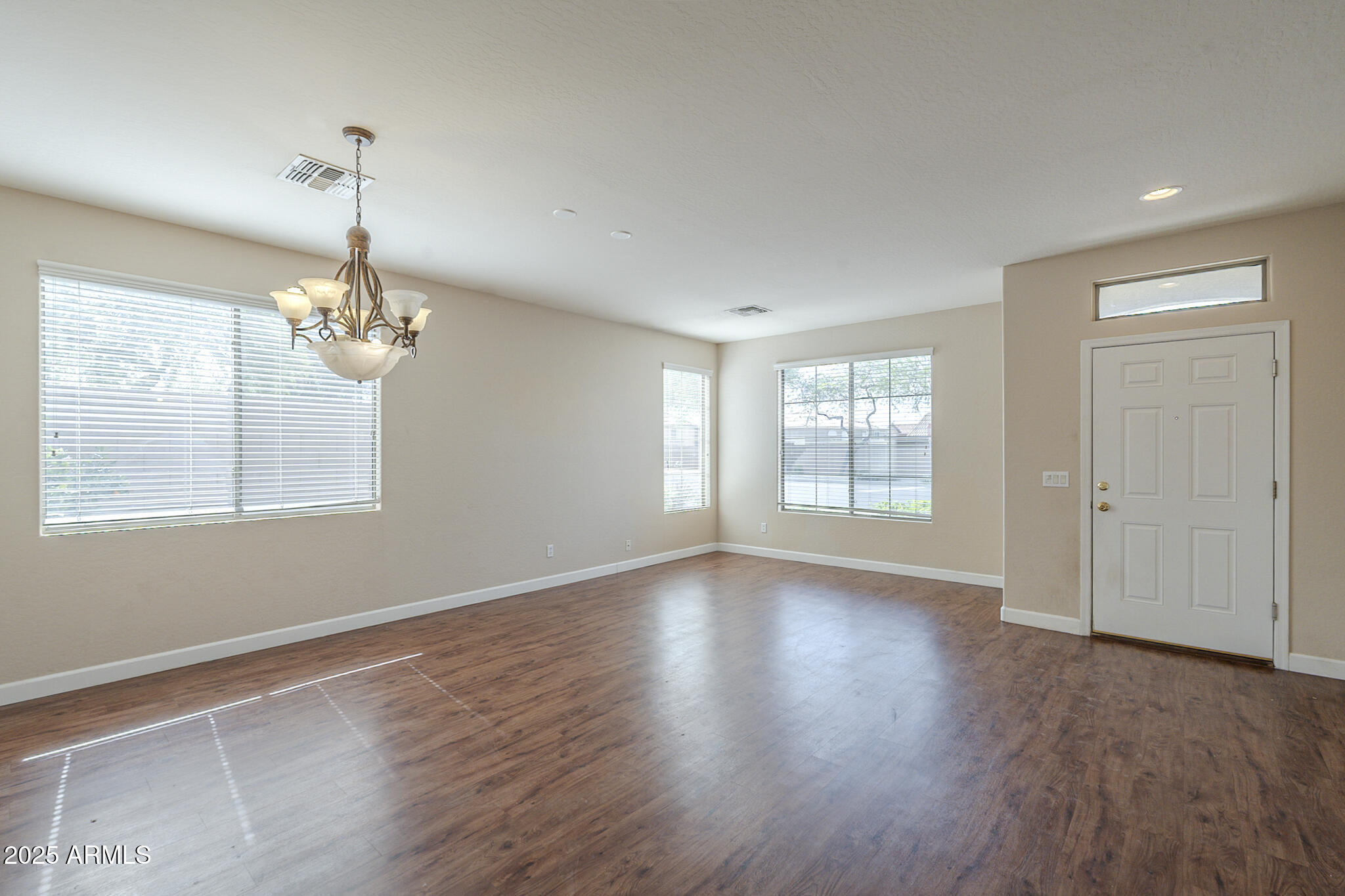 15902 West Hearn Road Surprise, AZ 85379 - Photo 32 of 73 a view of an empty room with wooden floor and a window