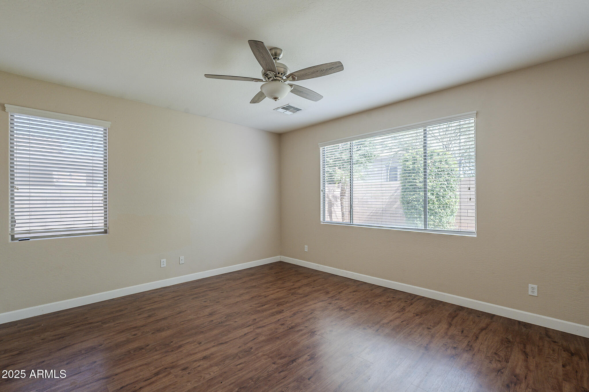 15902 West Hearn Road Surprise, AZ 85379 - Photo 44 of 73 a view of a big room with wooden floor closet and windows