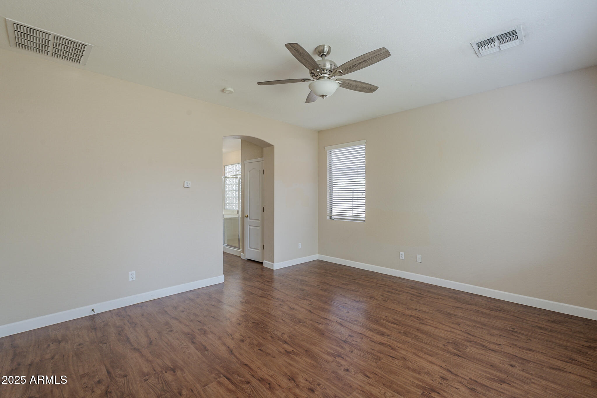 15902 West Hearn Road Surprise, AZ 85379 - Photo 47 of 73 an empty room with wooden floor and windows