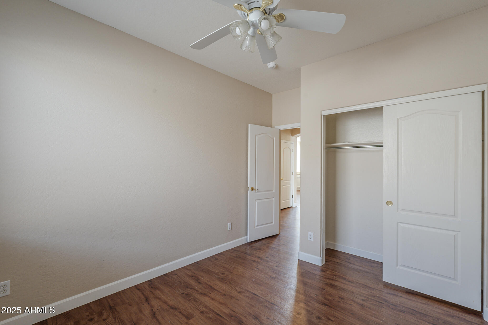 15902 West Hearn Road Surprise, AZ 85379 - Photo 57 of 73 a view of an empty room with wooden floor