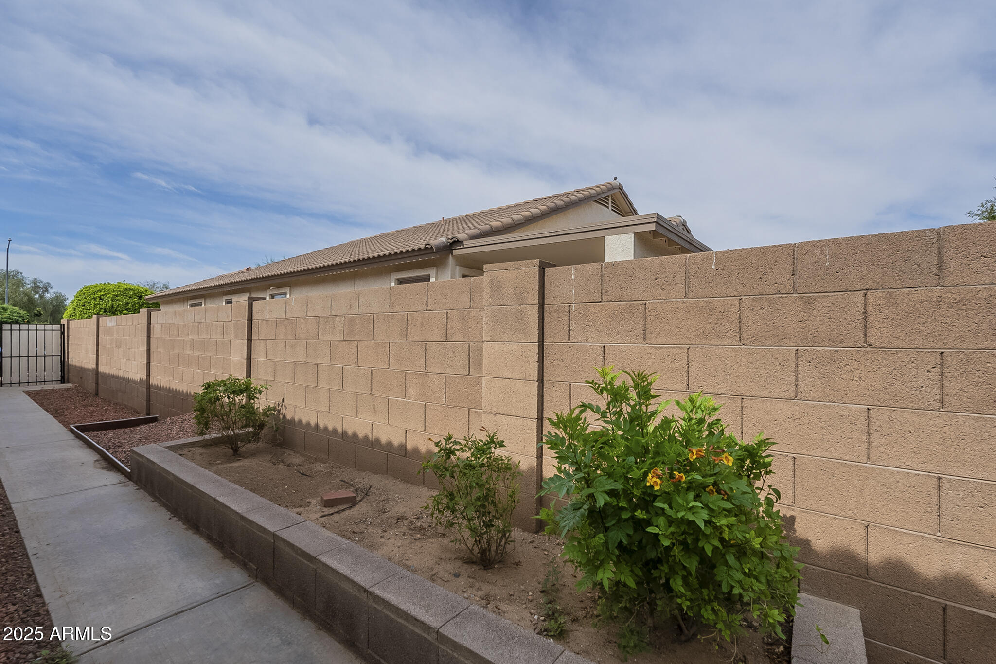 15902 West Hearn Road Surprise, AZ 85379 - Photo 65 of 73 a backyard of a house with potted plants and seating space