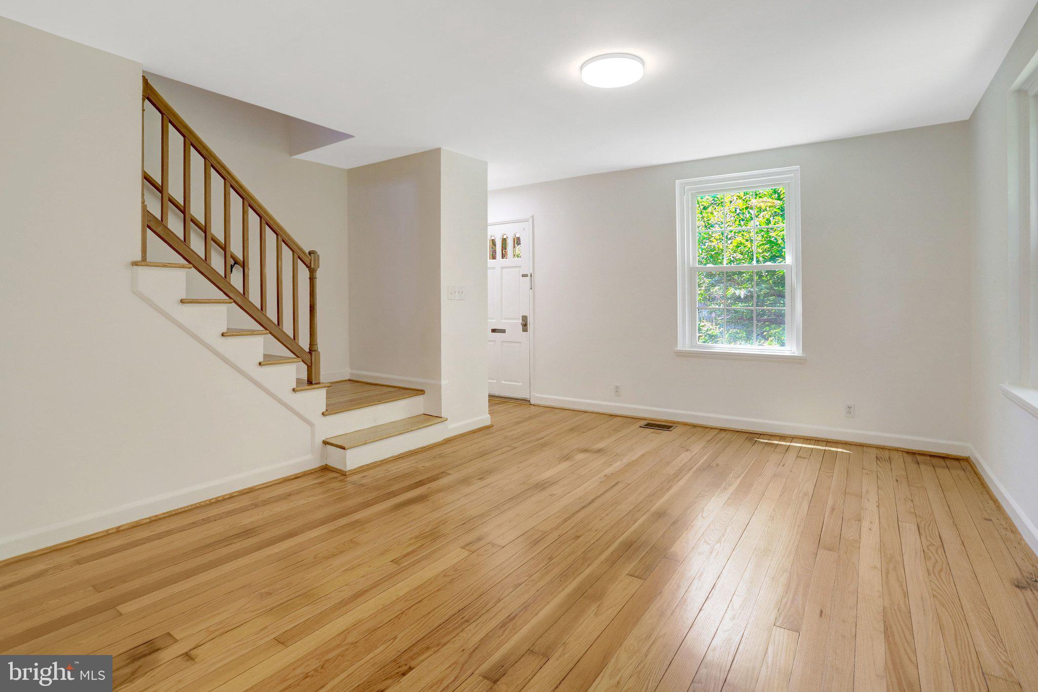 4837 27th Road South Arlington, VA 22206 - Photo 13 of 34 a view of an empty room with wooden floor and a window
