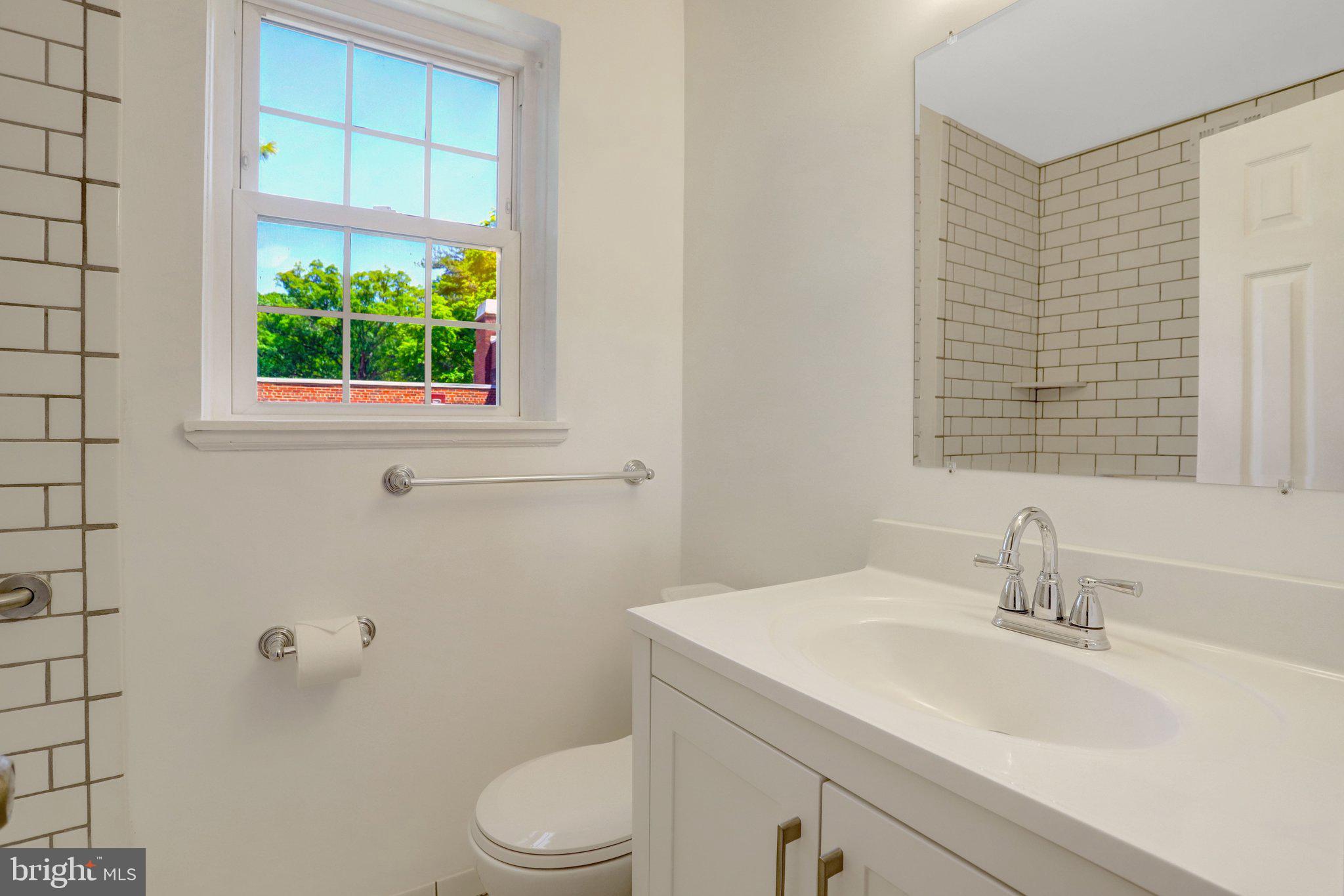 4837 27th Road South Arlington, VA 22206 - Photo 19 of 34 a bathroom with a sink a toilet and a window