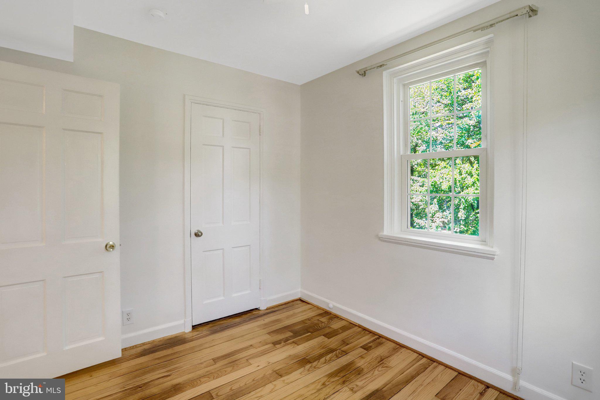 4837 27th Road South Arlington, VA 22206 - Photo 20 of 34 a view of an empty room with wooden floor and a window
