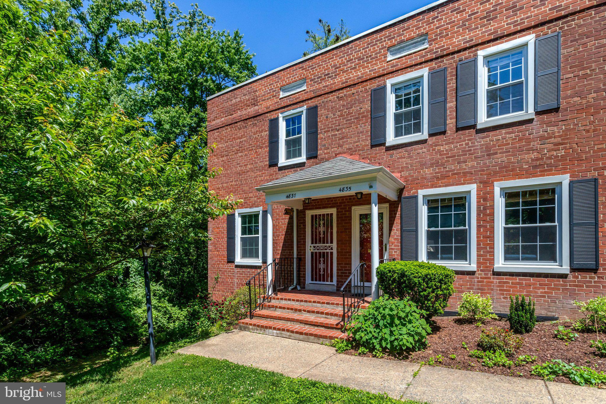 4837 27th Road South Arlington, VA 22206 - Photo 32 of 34 a front view of a house with garden and trees