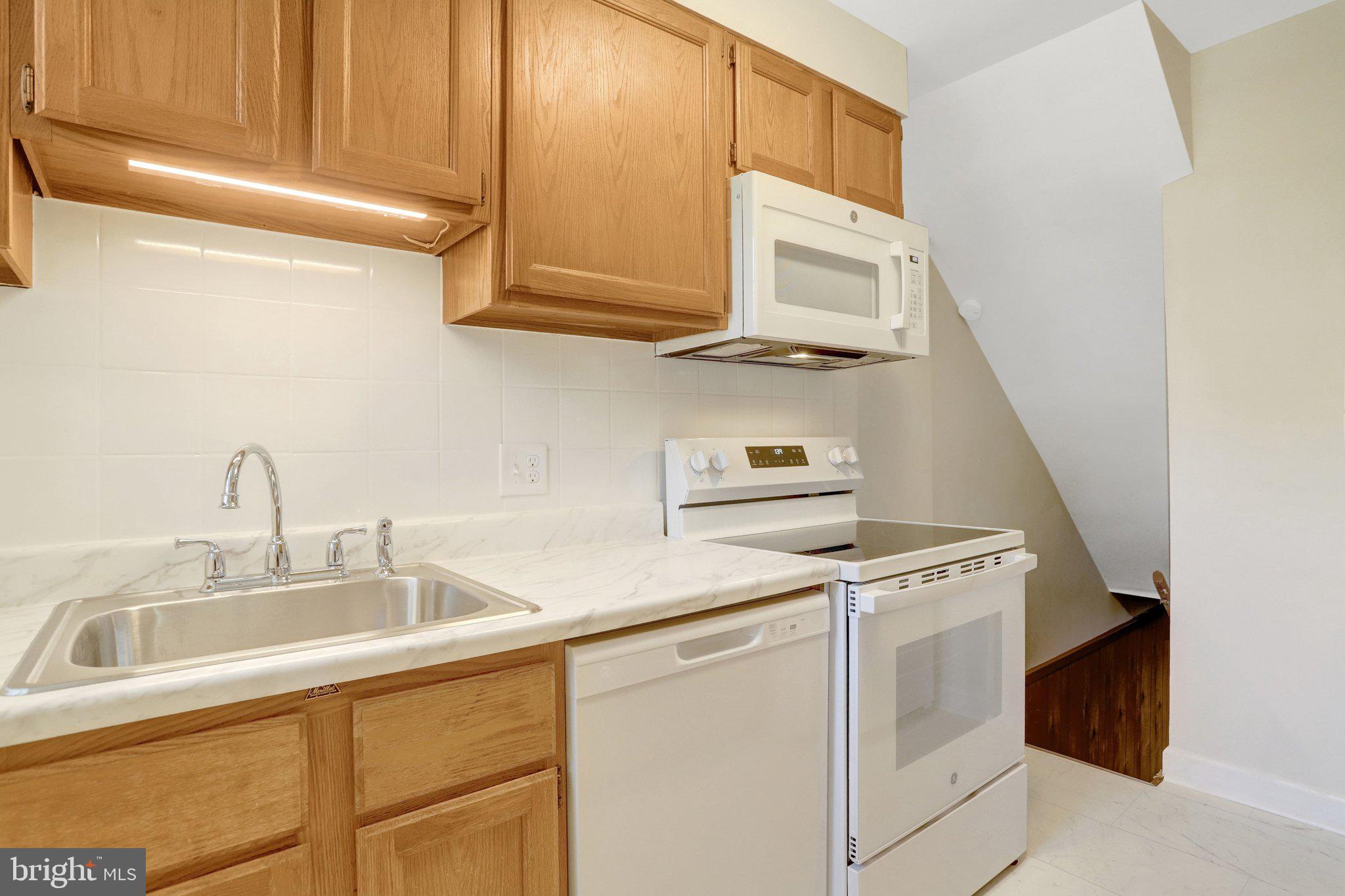 4837 27th Road South Arlington, VA 22206 - Photo 5 of 34 a kitchen with stainless steel appliances granite countertop a sink and a microwave