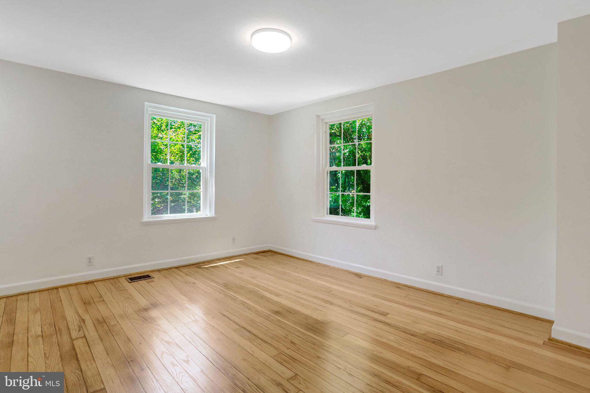 4837 27th Road South Arlington, VA 22206 - Photo 10 of 34 an empty room with wooden floor and windows