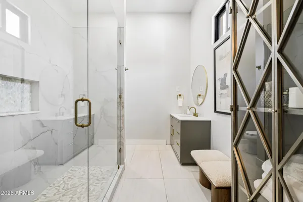 a bathroom with a sink mirror and toilet