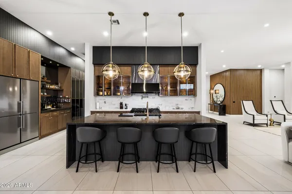 a kitchen with stainless steel appliances granite countertop a sink a stove and a wooden floors