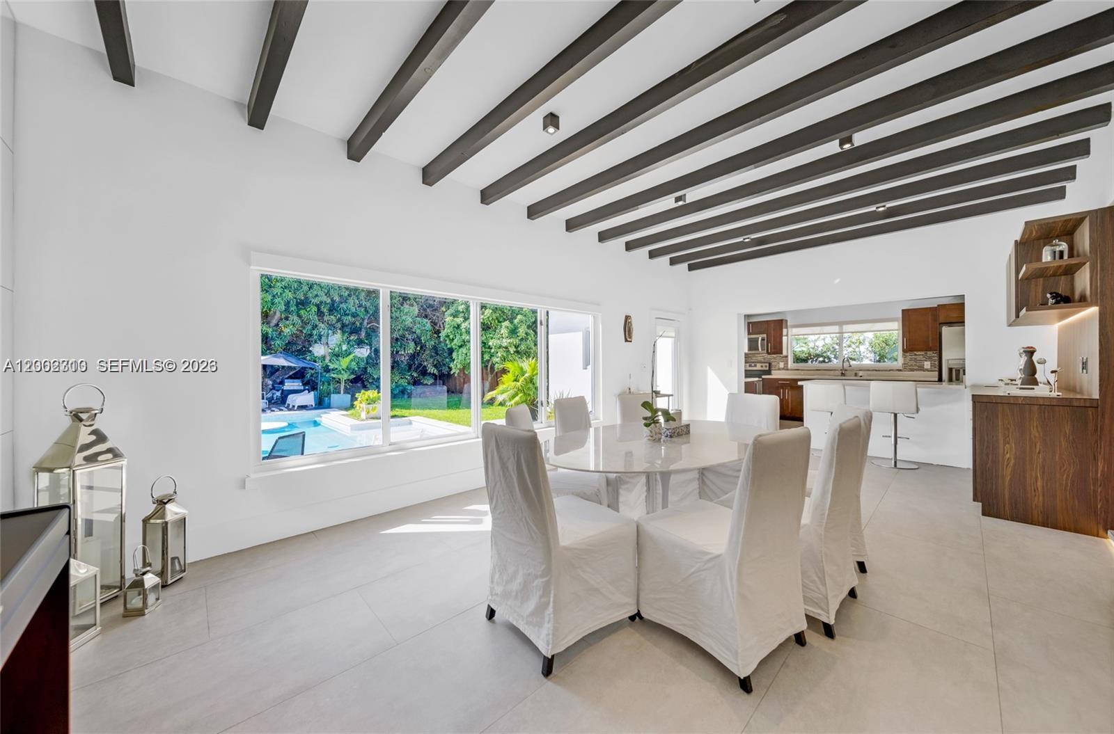 3531 Southwest 1st Avenue Miami, FL 33145 - Photo 11 of 44 a dining room with furniture and a floor to ceiling window