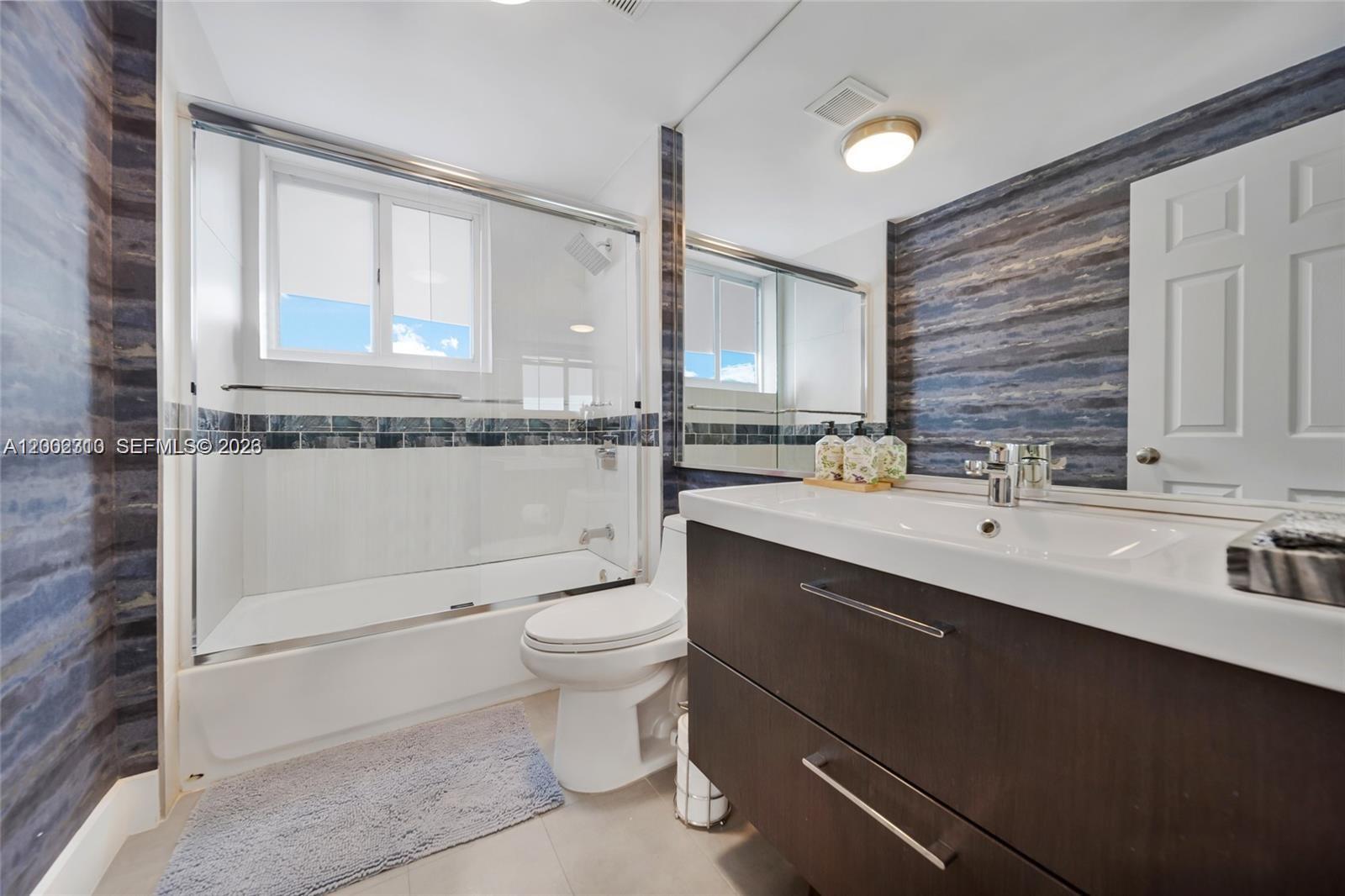 3531 Southwest 1st Avenue Miami, FL 33145 - Photo 12 of 44 a bathroom with a toilet sink double vanity and mirror