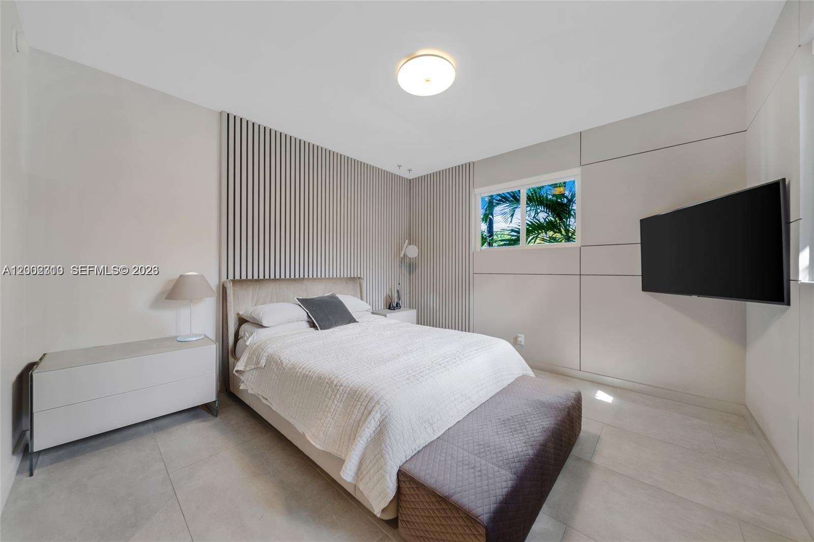 3531 Southwest 1st Avenue Miami, FL 33145 - Photo 15 of 44 a bedroom with a bed and a flat screen tv