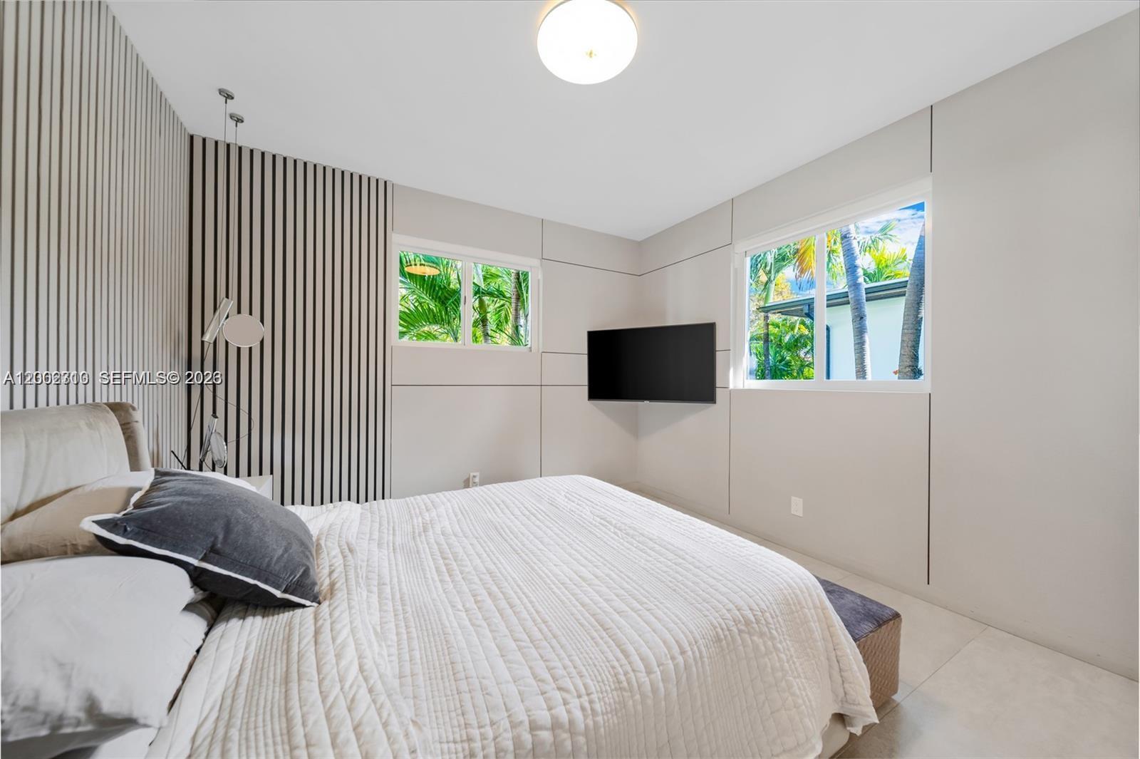 3531 Southwest 1st Avenue Miami, FL 33145 - Photo 16 of 44 a bedroom with a bed and a flat screen tv