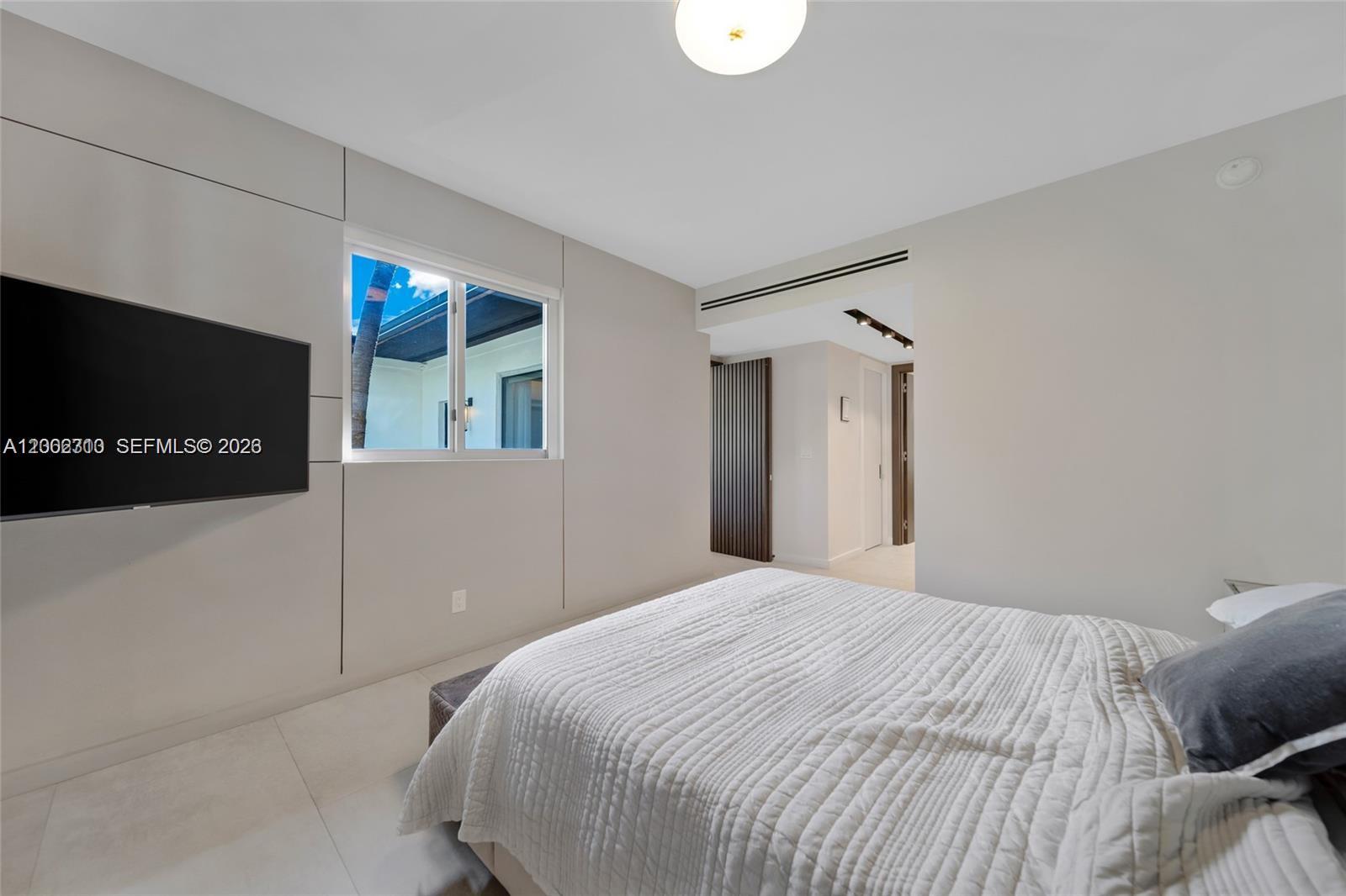 3531 Southwest 1st Avenue Miami, FL 33145 - Photo 17 of 44 a bedroom with a bed and a flat screen tv