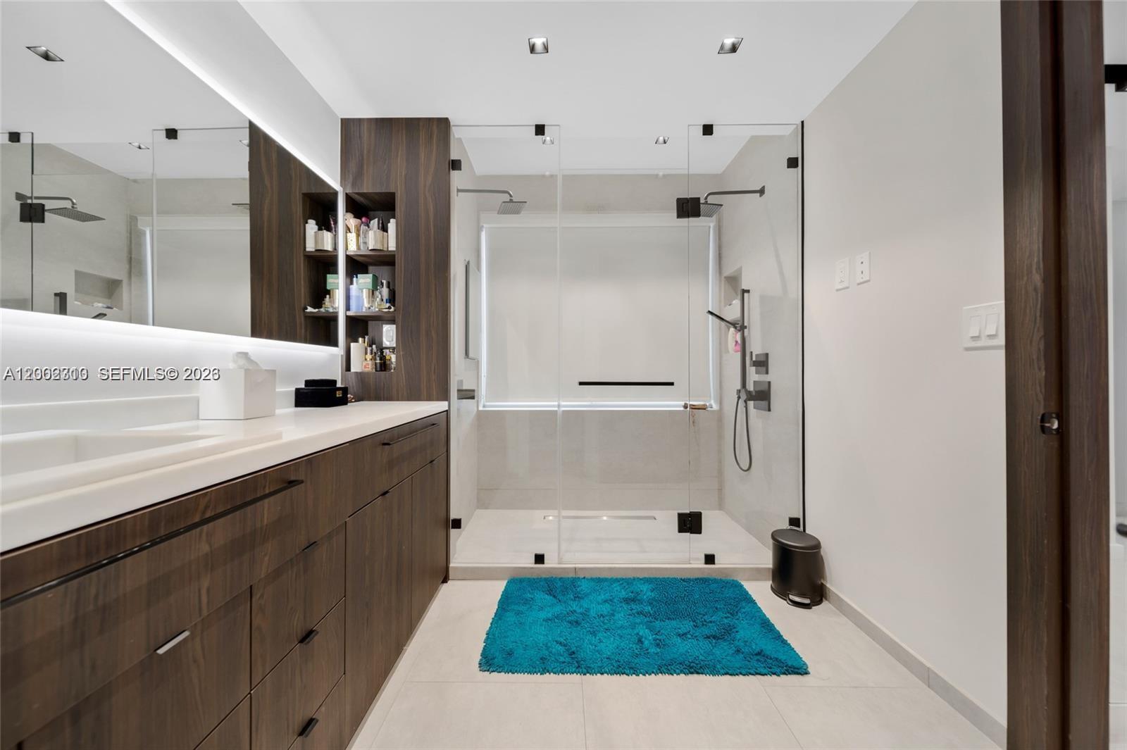 3531 Southwest 1st Avenue Miami, FL 33145 - Photo 18 of 44 a bathroom with a shower sink and mirror