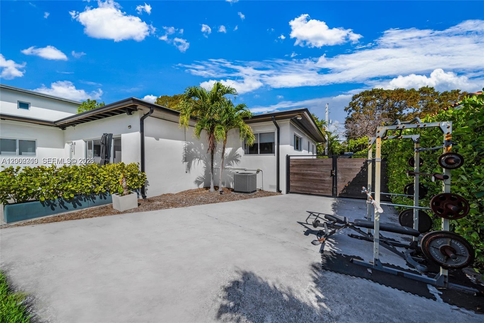 3531 Southwest 1st Avenue Miami, FL 33145 - Photo 2 of 44 a front view of a house with a yard and a garage