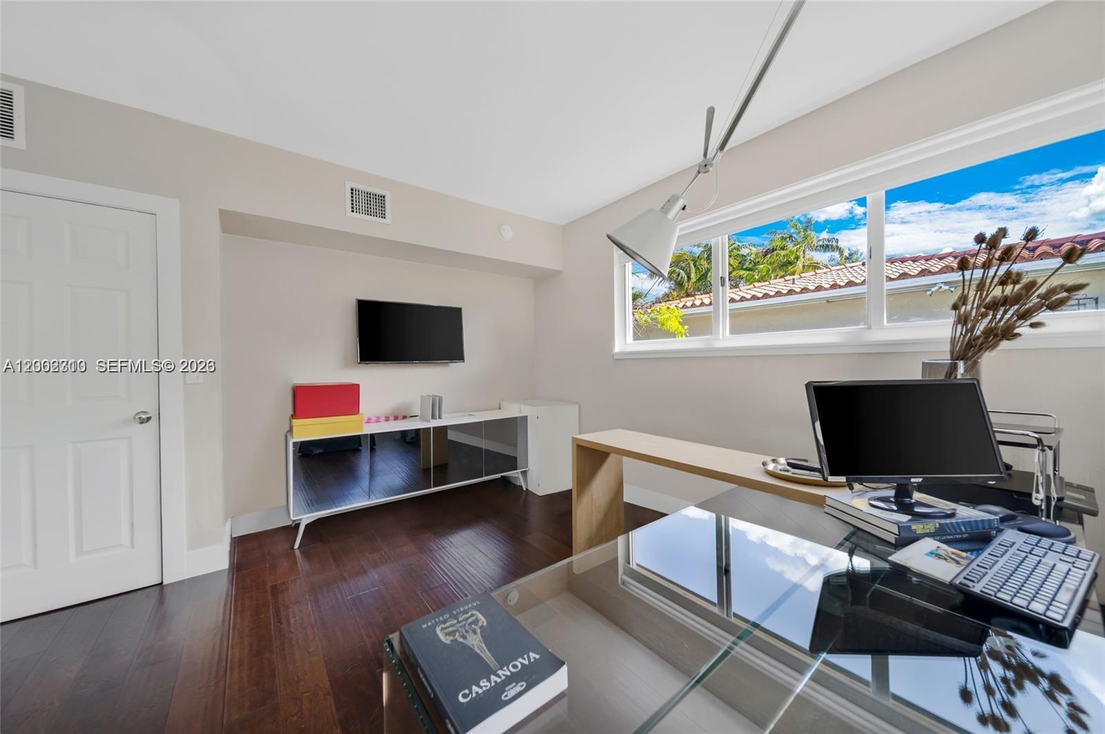 3531 Southwest 1st Avenue Miami, FL 33145 - Photo 22 of 44 a view of a workspace with furniture and a flat screen tv