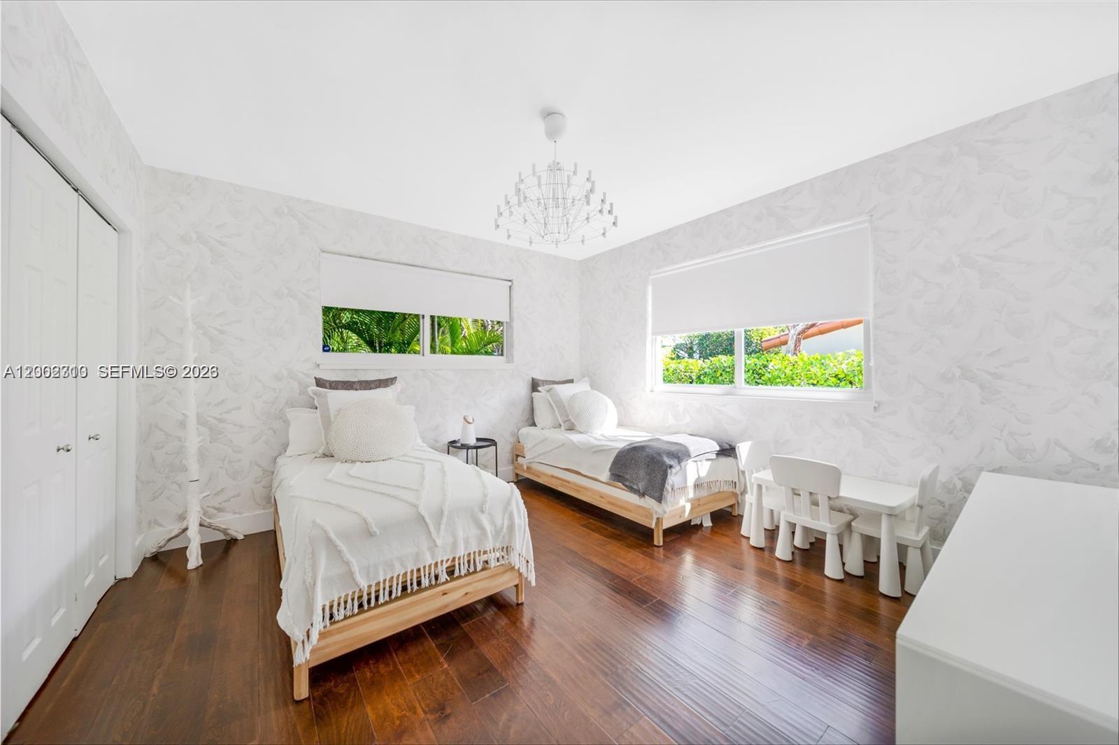 3531 Southwest 1st Avenue Miami, FL 33145 - Photo 25 of 44 a bedroom with a bed and a chandelier