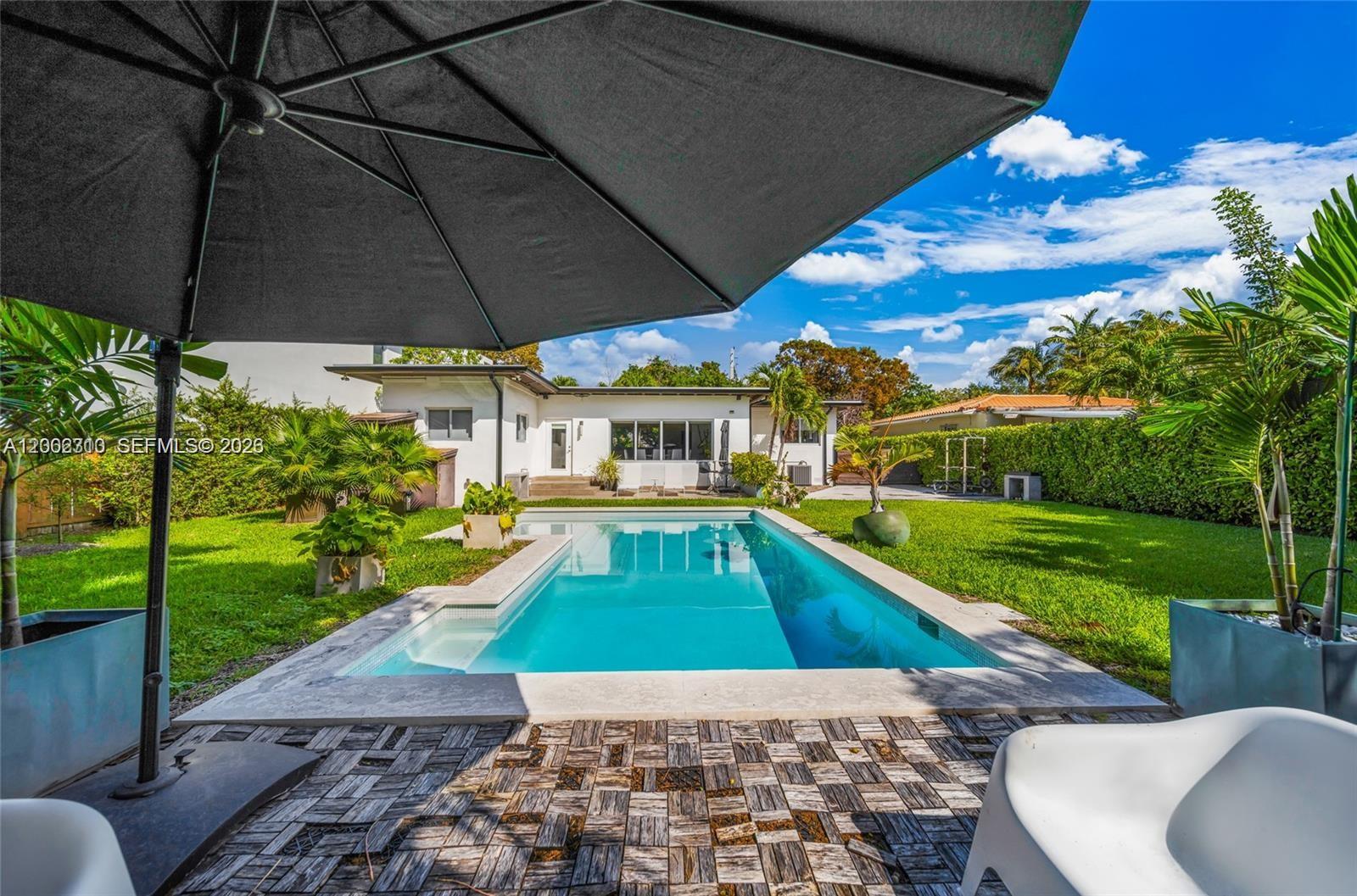 3531 Southwest 1st Avenue Miami, FL 33145 - Photo 44 of 44 a view of a patio with a table and chairs under an umbrella