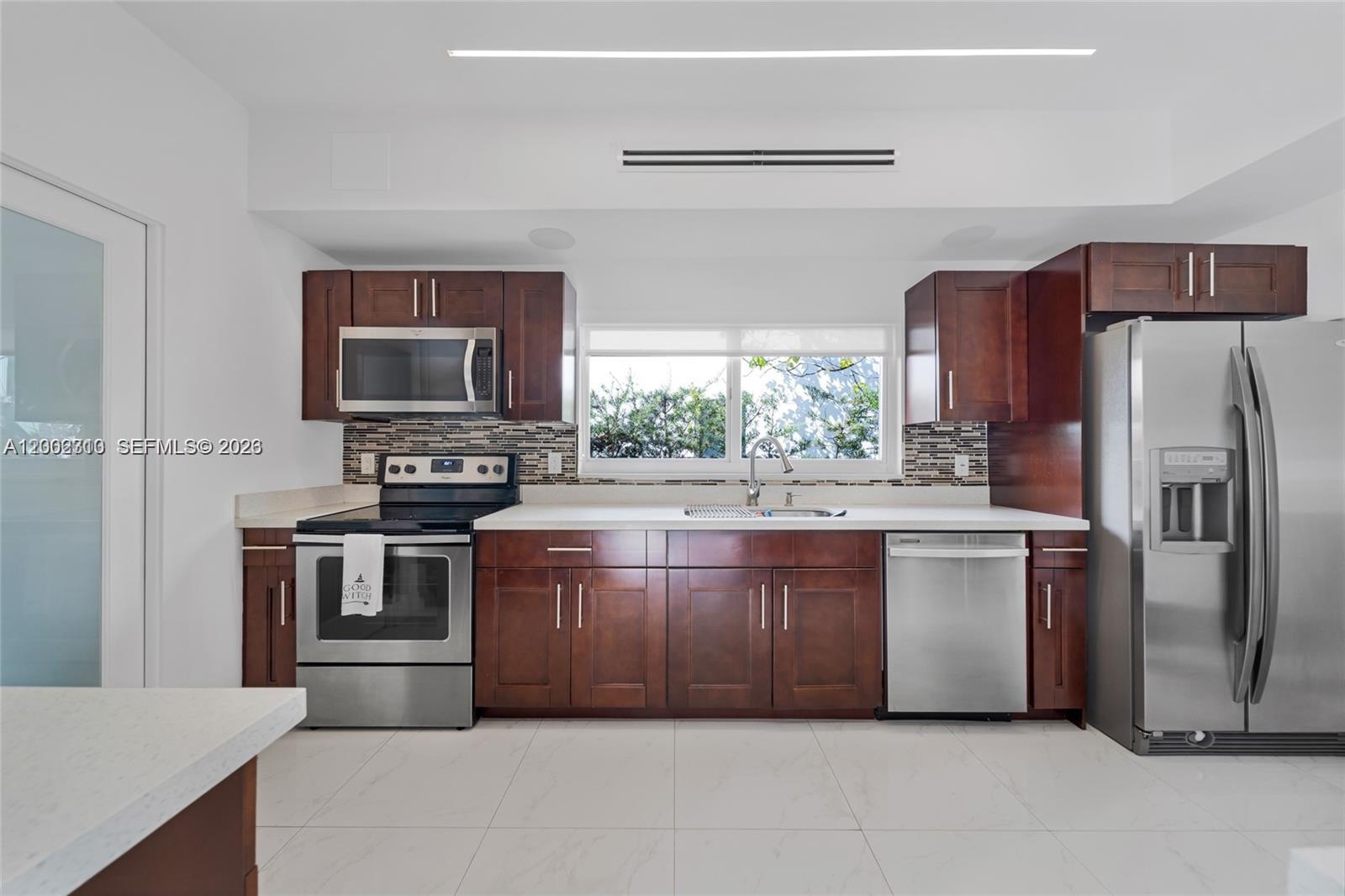 3531 Southwest 1st Avenue Miami, FL 33145 - Photo 6 of 44 a kitchen with stainless steel appliances granite countertop a refrigerator stove and oven
