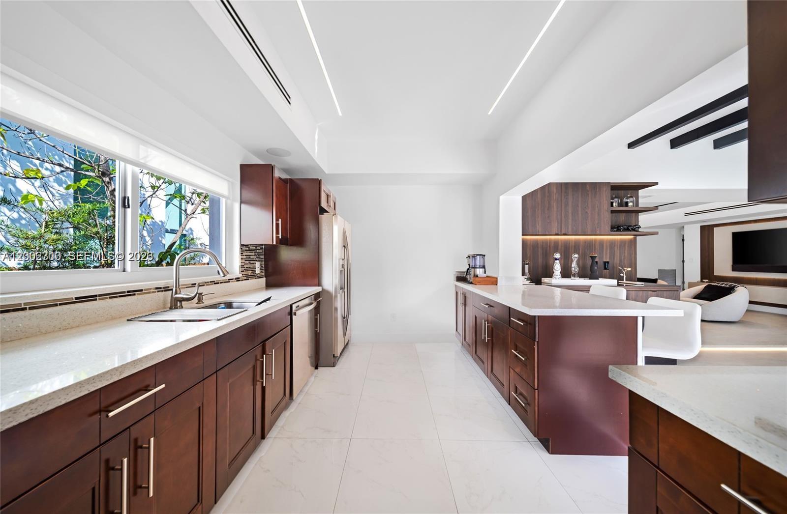 3531 Southwest 1st Avenue Miami, FL 33145 - Photo 8 of 44 a kitchen with a sink and wooden cabinets