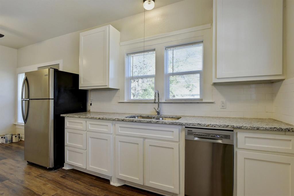 1115 South Rusk Avenue Denison, TX 75020 - Photo 10 of 21 a kitchen with stainless steel appliances granite countertop a refrigerator sink and cabinets