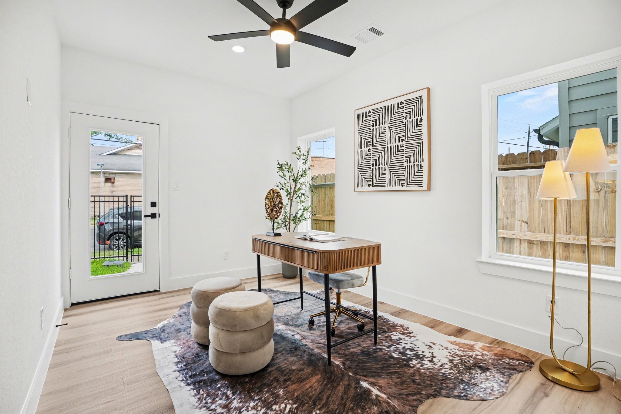 115 Milby Street Houston, TX 77003 - Photo 18 of 28 This bright, modern home office (or secondary bedroom) features large windows, a glass door for natural light, and a full walk-in close, and bathroom.