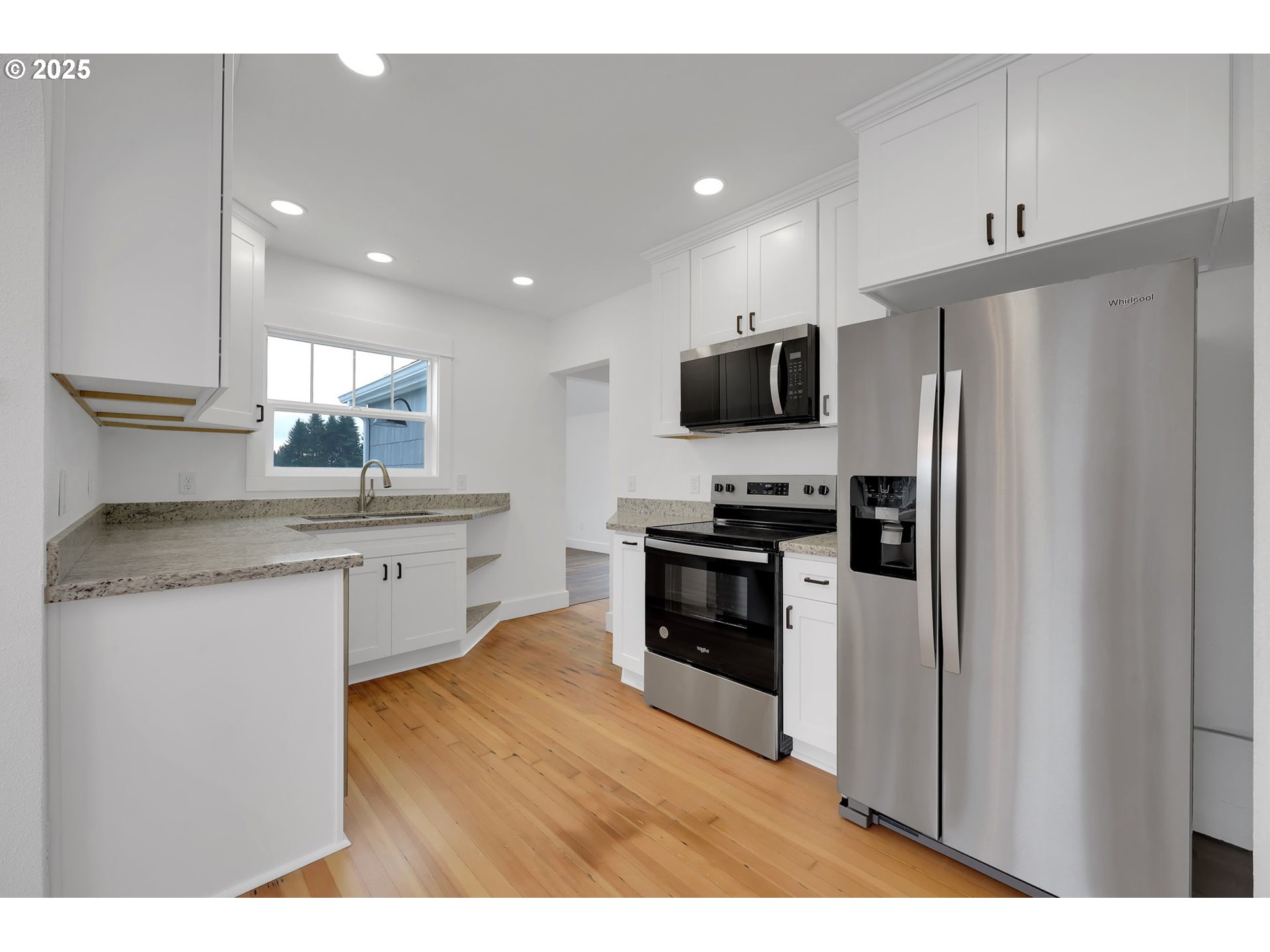 92910 River Road Junction City, OR 97448 - Photo 11 of 43 a kitchen with stainless steel appliances a refrigerator stove microwave and sink