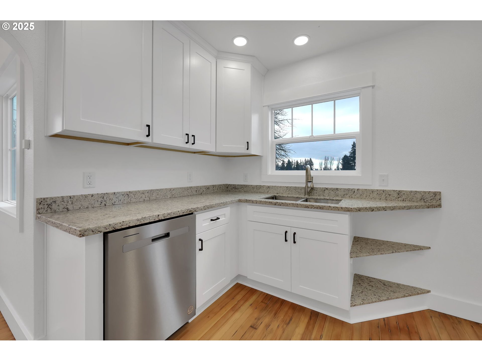 92910 River Road Junction City, OR 97448 - Photo 12 of 43 a kitchen with granite countertop a sink dishwasher a stove and white cabinets