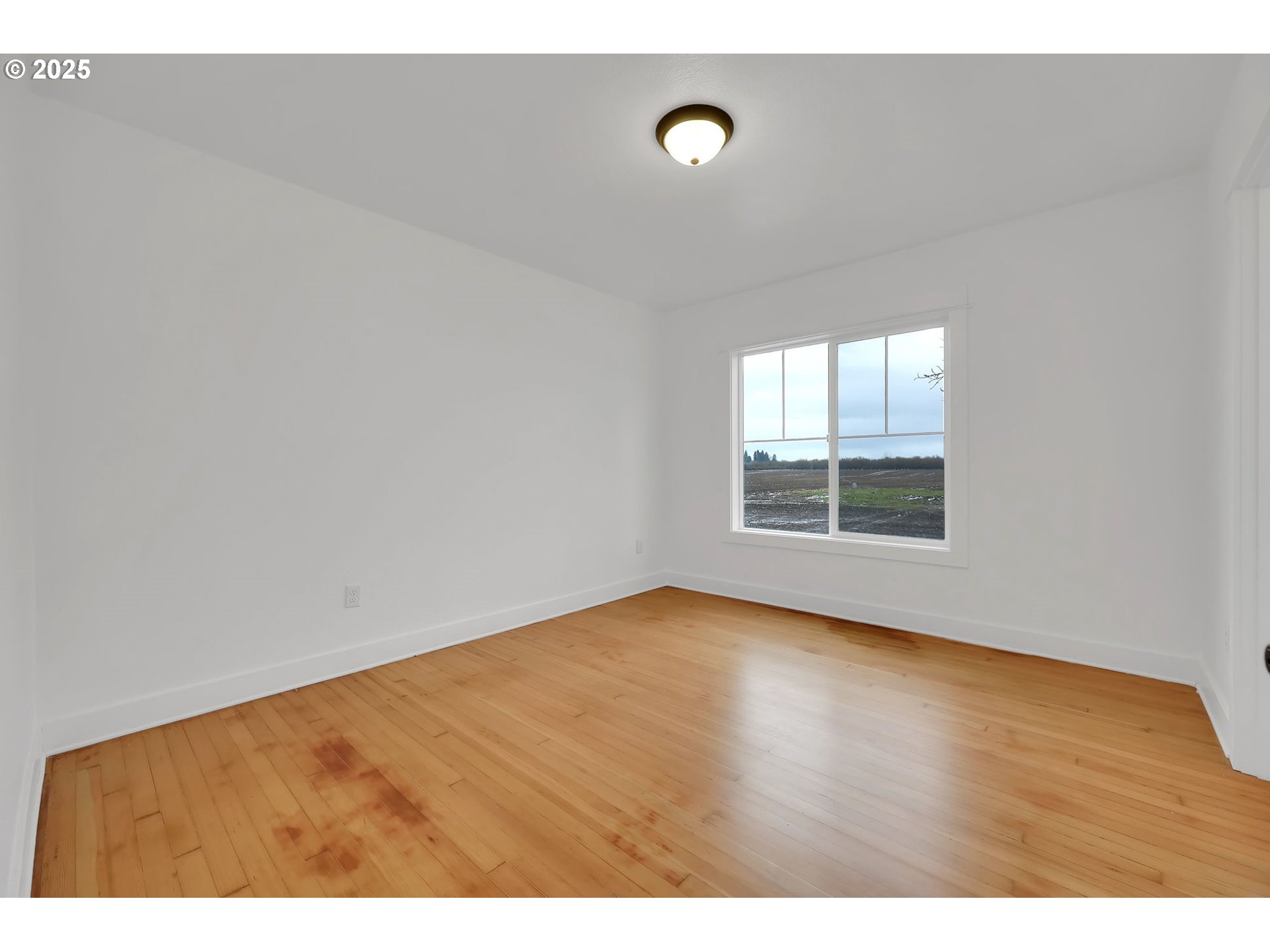 92910 River Road Junction City, OR 97448 - Photo 23 of 43 a view of an empty room with wooden floor and a window