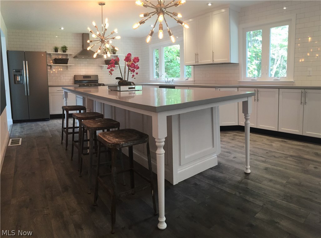 9208 New Road North Jackson, OH 44451 - Photo 2 of 31 The MASSIVE kitchen island measures 12 x 4' and could comfortably seat 7+ people. This custom built piece was topped with a solid surface Corian counter.