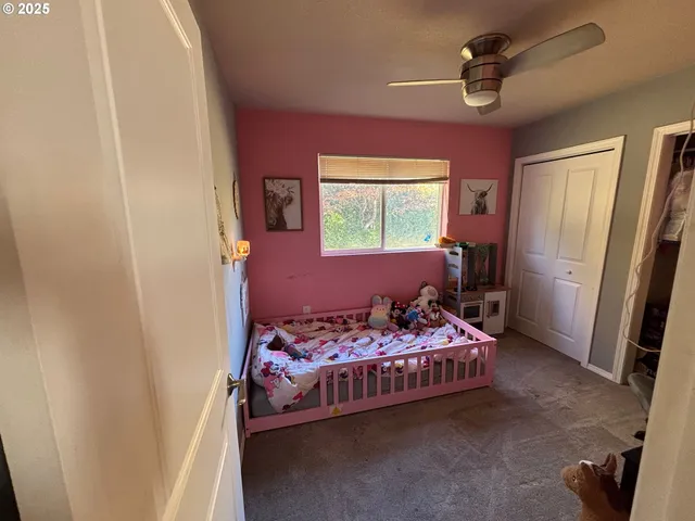 a bedroom with bed and a window