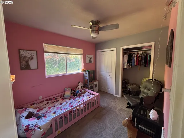 a bedroom with bed and a window