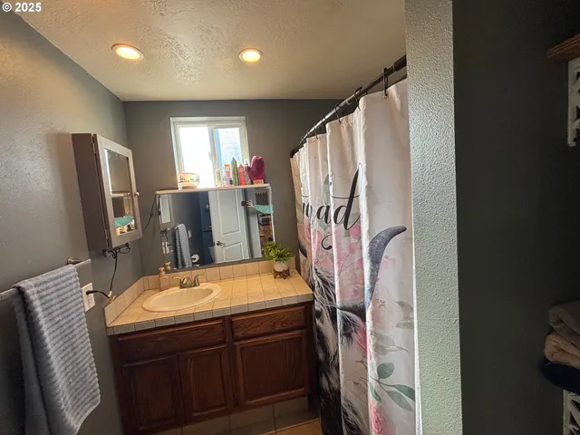 a view of a hallway with workspace and windows