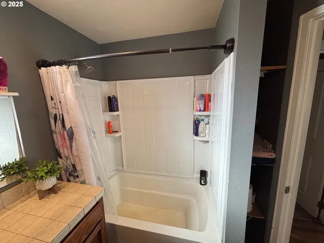 a bathroom with a shower and a tub