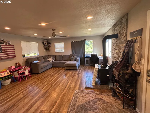 a living room with furniture a window and a flat screen tv