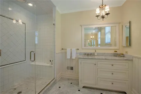 a spacious bedroom with a balcony a bed and a flat screen tv