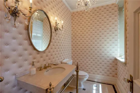 a bathroom with a sink a toilet and a mirror