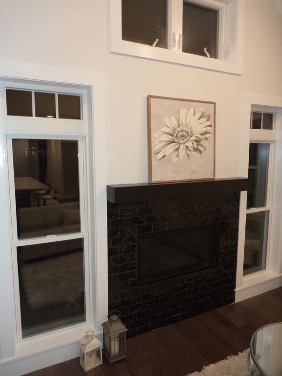 4 Wells Street Natick, MA 01760 - Photo 12 of 38 a living room with a fireplace and a walk in closet