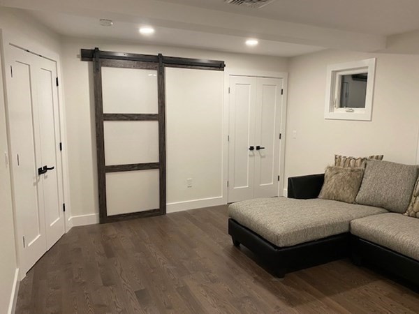 4 Wells Street Natick, MA 01760 - Photo 16 of 38 a spacious bedroom with a bed and a chandelier