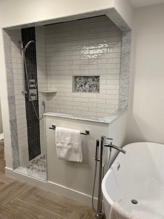 4 Wells Street Natick, MA 01760 - Photo 20 of 38 a bathroom with a bathtub and shower