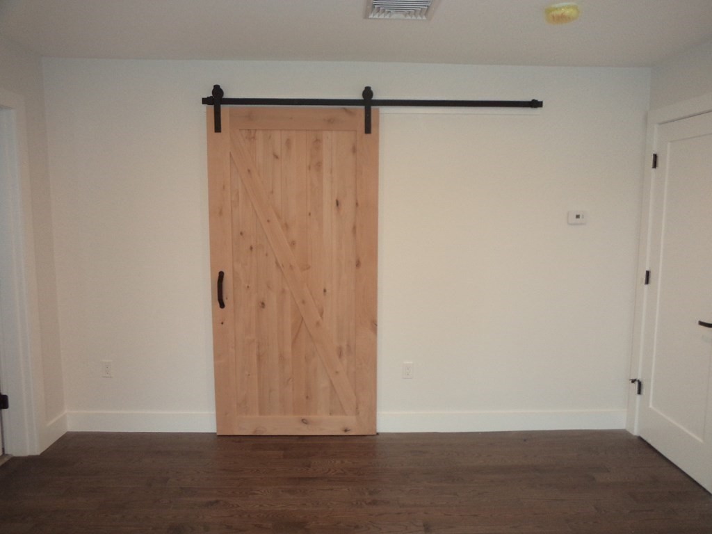 4 Wells Street Natick, MA 01760 - Photo 25 of 38 a view of walk in closet with wooden floor